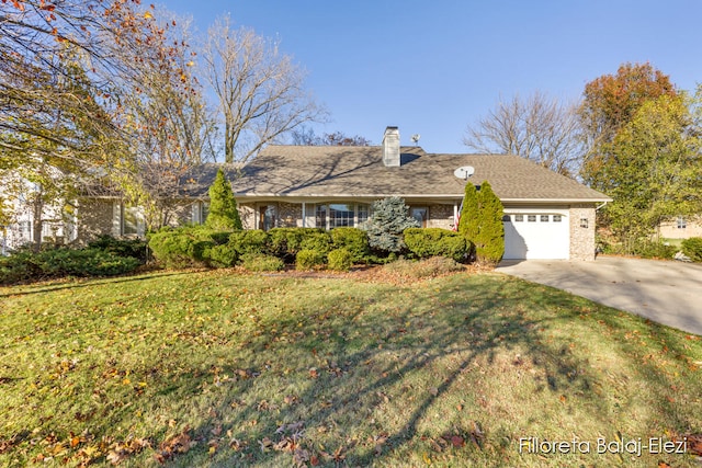 view of front of home with a garage and a front lawn