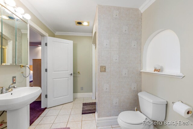 bathroom with ornamental molding, sink, tile patterned floors, toilet, and tile walls