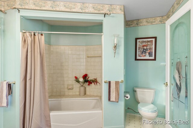 bathroom with toilet and shower / bath combination with curtain