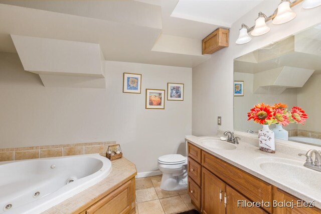 bathroom featuring toilet, vanity, a relaxing tiled tub, and tile patterned floors