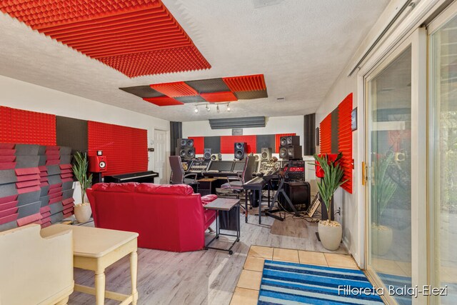 living room featuring a textured ceiling and light wood-type flooring