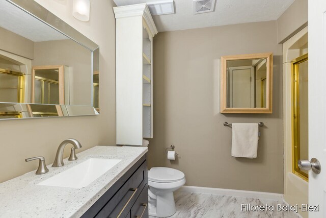 full bathroom with vanity, toilet, and bath / shower combo with glass door