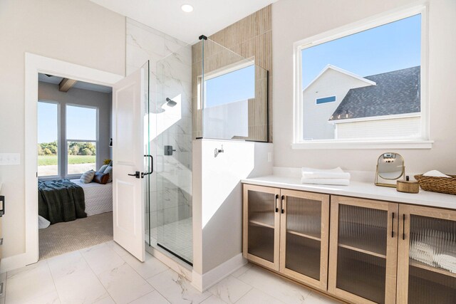 bathroom with an enclosed shower and vanity