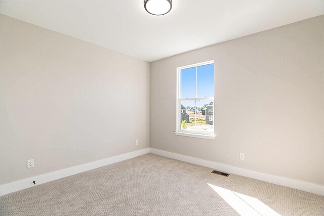 spare room with light colored carpet