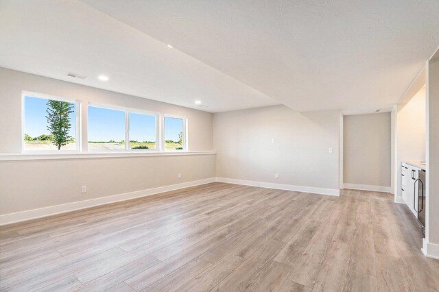 unfurnished room with light wood-type flooring