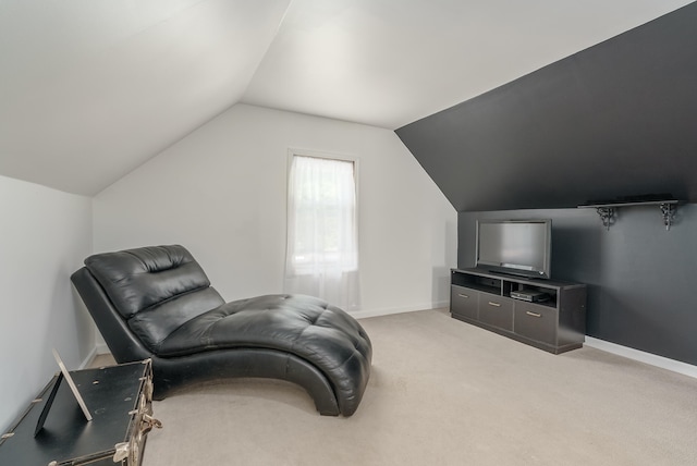 living area featuring carpet flooring and lofted ceiling