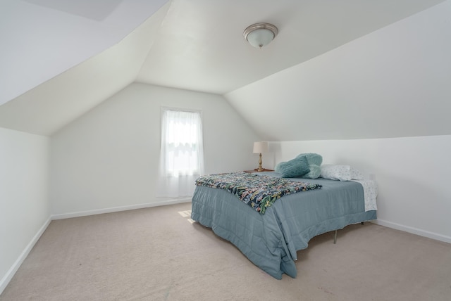 bedroom with lofted ceiling and carpet