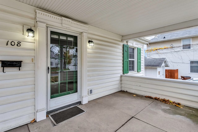 view of exterior entry with a porch