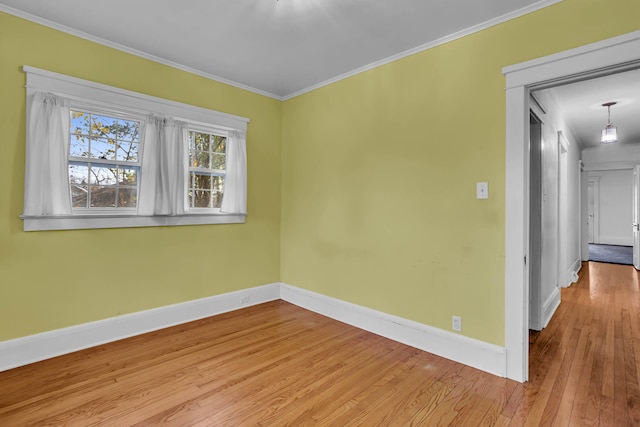 unfurnished room with ornamental molding and light hardwood / wood-style flooring