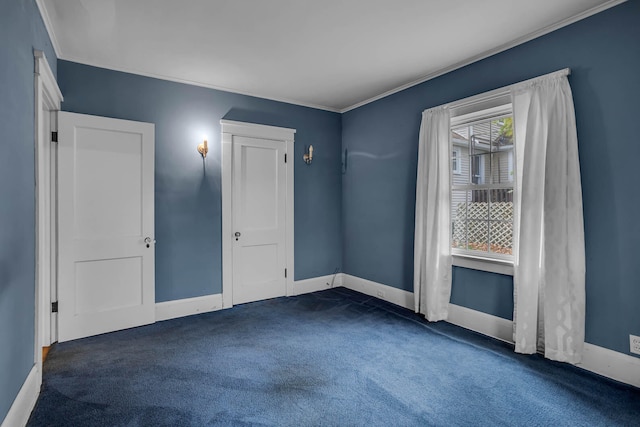 carpeted spare room featuring crown molding