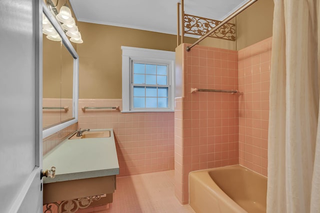 bathroom featuring tile patterned floors, tile walls, vanity, crown molding, and shower / bath combination with curtain