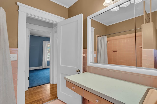 bathroom with wood-type flooring, curtained shower, and crown molding