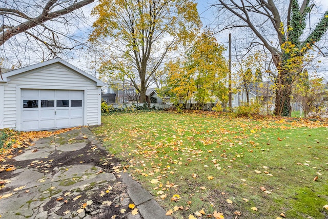 view of yard with a garage and an outdoor structure