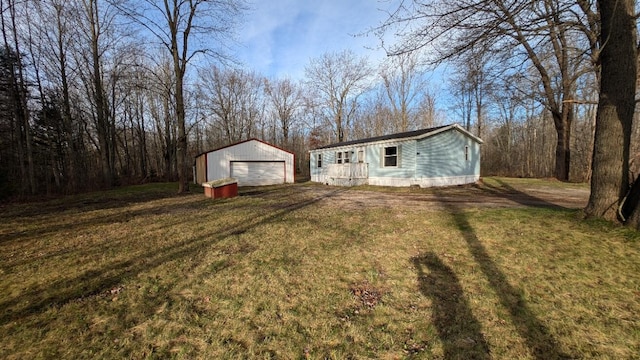 exterior space with an outbuilding, a garage, and a front yard