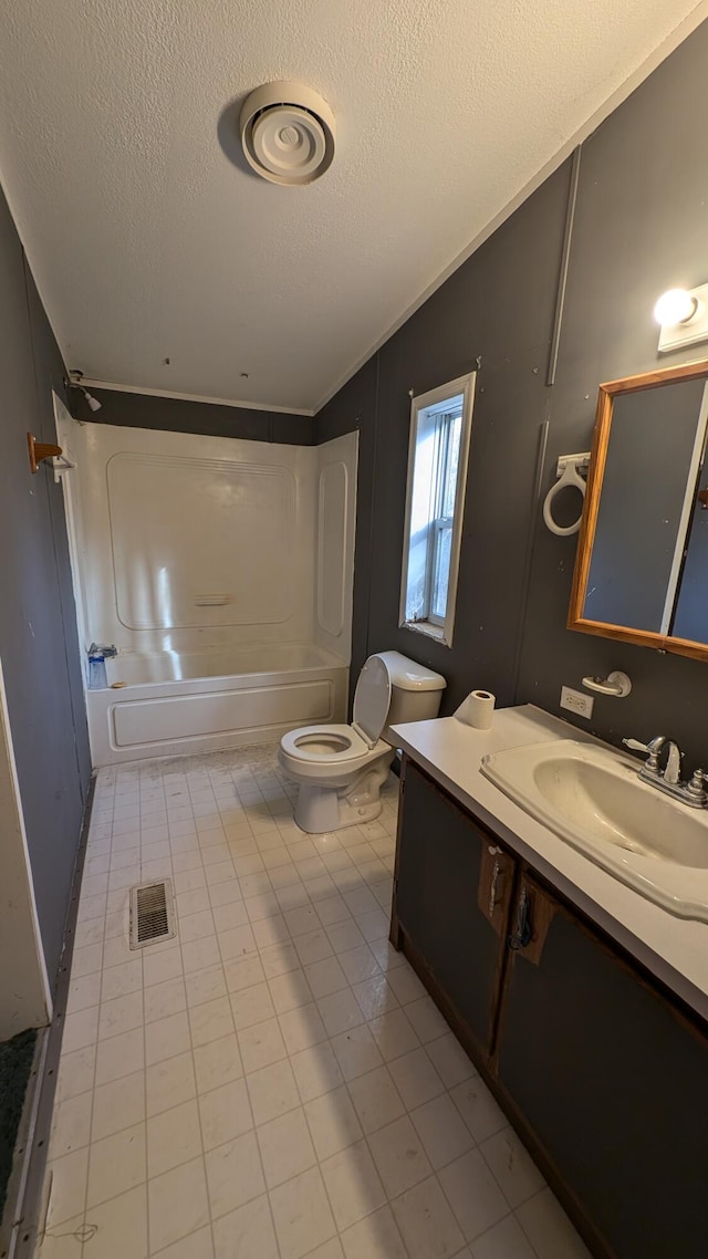 full bathroom with vanity, a textured ceiling,  shower combination, vaulted ceiling, and toilet