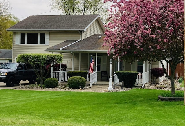 view of front of house with covered porch and a front lawn