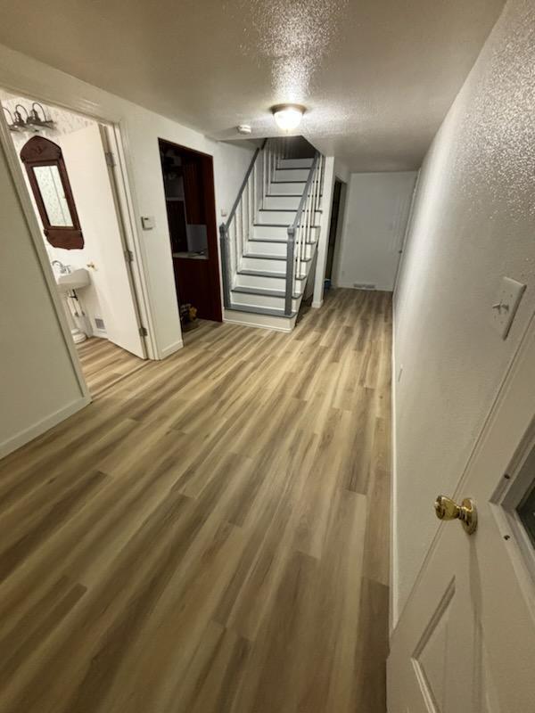 interior space with wood-type flooring and a textured ceiling