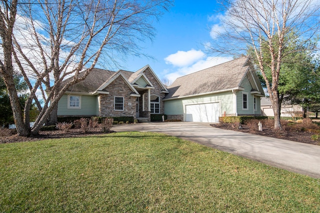 view of front of home with a front yard and a garage