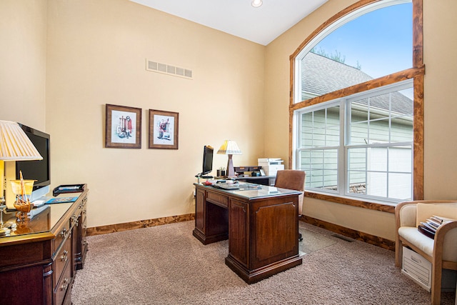 office space featuring carpet flooring and a towering ceiling