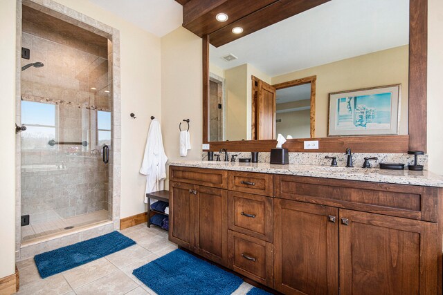 bathroom featuring vanity, tile patterned floors, and a shower with shower door