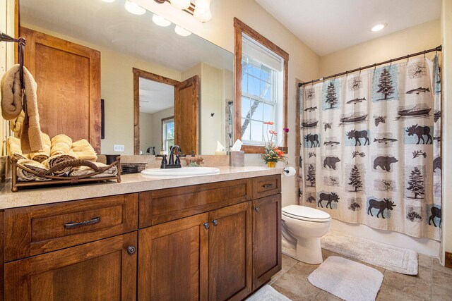 full bathroom featuring tile patterned flooring, vanity, shower / tub combo, and toilet