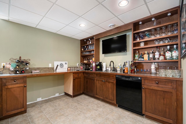 bar with sink, light tile patterned floors, a drop ceiling, and black dishwasher