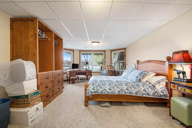 bedroom featuring a paneled ceiling and carpet floors