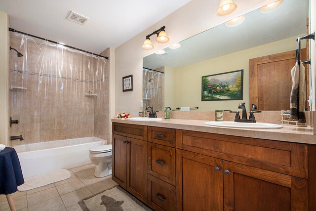 full bathroom featuring tile patterned flooring, vanity, toilet, and shower / bath combo with shower curtain