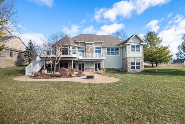 view of front of home featuring a wooden deck, a patio area, and a front yard