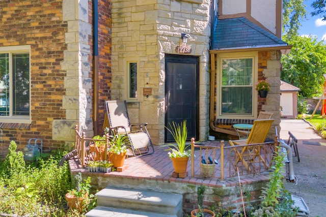 view of exterior entry with a patio area