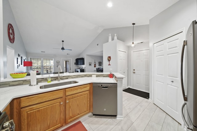 kitchen featuring ceiling fan, sink, pendant lighting, vaulted ceiling, and appliances with stainless steel finishes