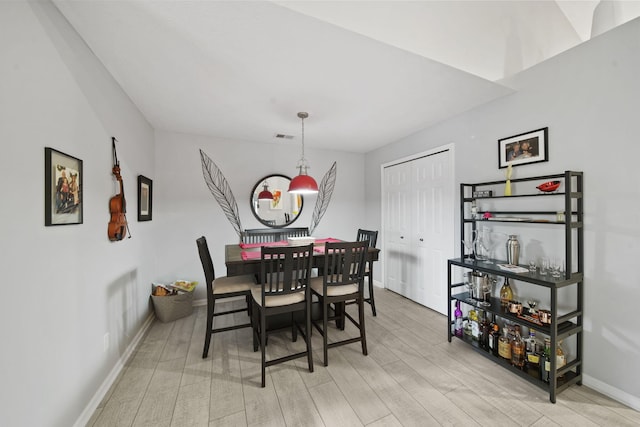 dining space with light wood-type flooring