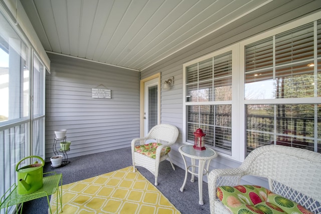 sunroom / solarium with plenty of natural light and wooden ceiling