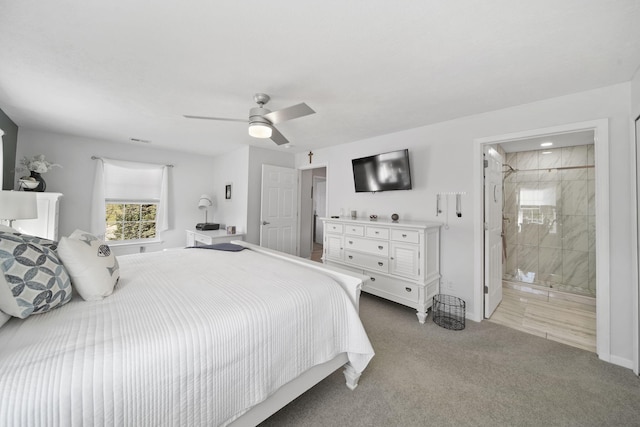 bedroom with ensuite bath, light carpet, and ceiling fan