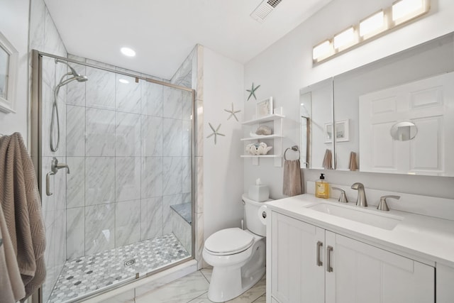 bathroom with vanity, toilet, and a shower with door