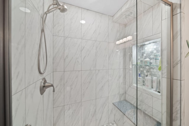 bathroom with a shower with shower door