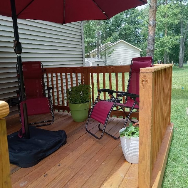 wooden terrace with a lawn