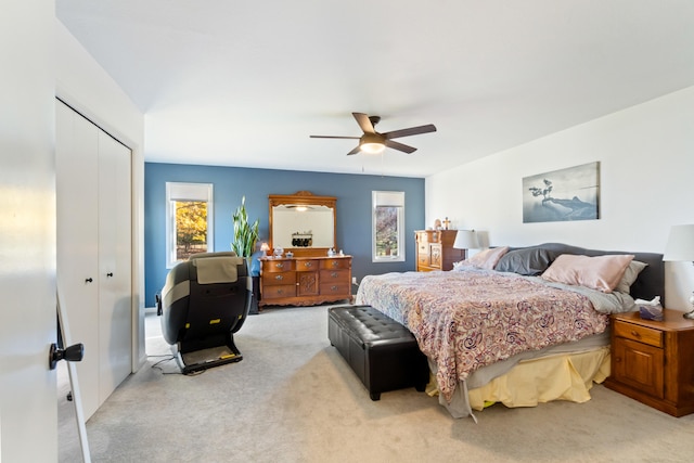 carpeted bedroom featuring a closet and ceiling fan