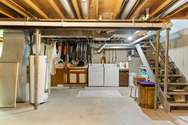 basement with heating unit, gas water heater, and washer and clothes dryer