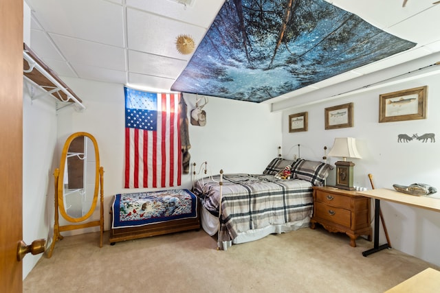 carpeted bedroom with a drop ceiling