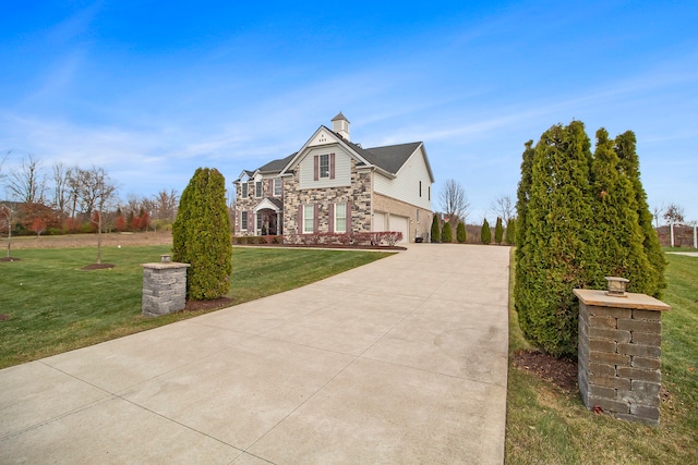 view of front of property featuring a garage and a front yard