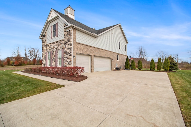 view of side of home with a garage and a yard