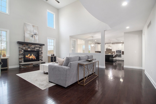 living room featuring plenty of natural light, dark hardwood / wood-style flooring, and a fireplace