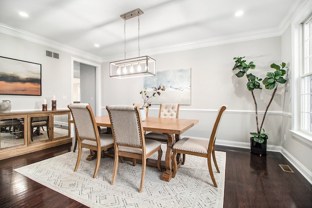 dining room featuring hardwood / wood-style flooring and crown molding