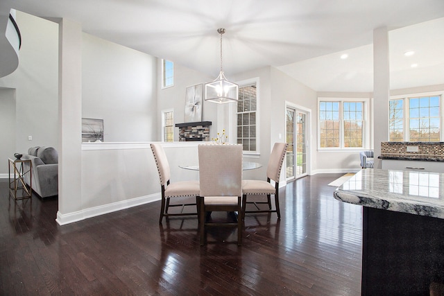 dining space featuring dark hardwood / wood-style flooring and a chandelier