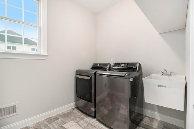 laundry room featuring sink and washing machine and clothes dryer