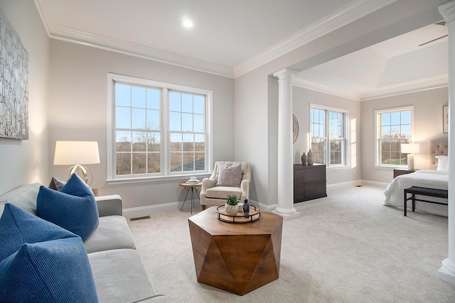 carpeted living room featuring decorative columns and ornamental molding