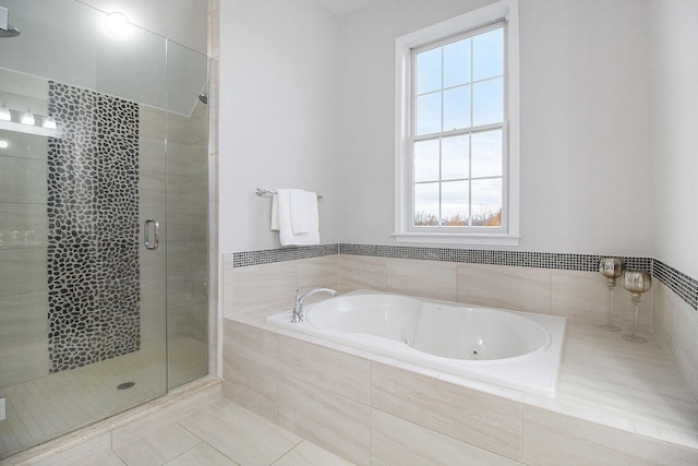 bathroom featuring tile patterned floors, a healthy amount of sunlight, and separate shower and tub