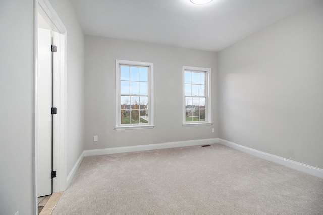 spare room with light carpet