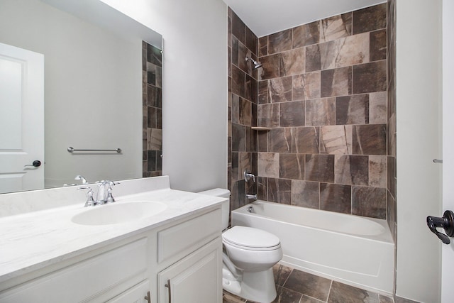 full bathroom featuring vanity, toilet, and tiled shower / bath